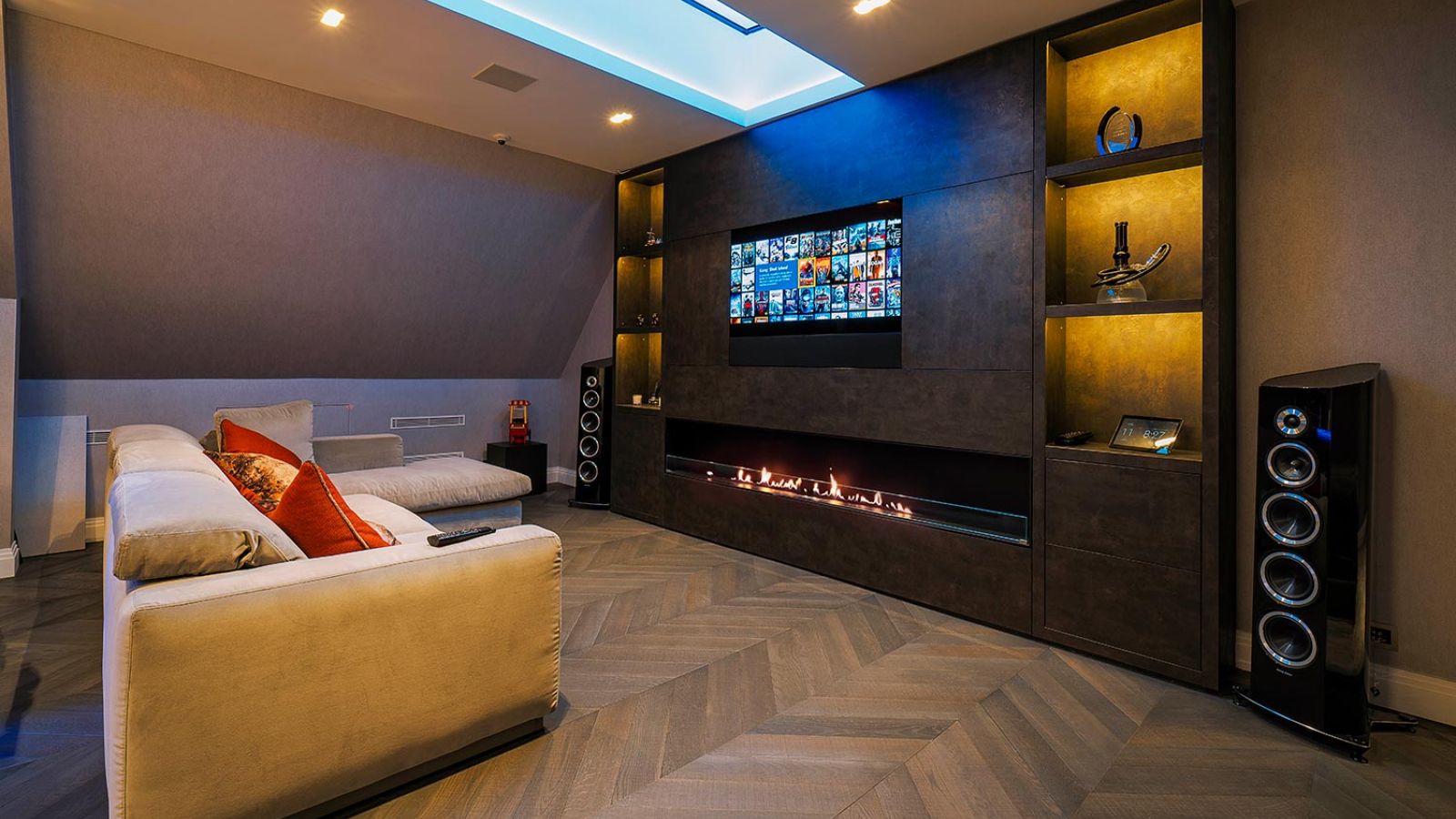 Elegant entertainment room with a fireplace, built-in shelves, and a movie selection on screen.