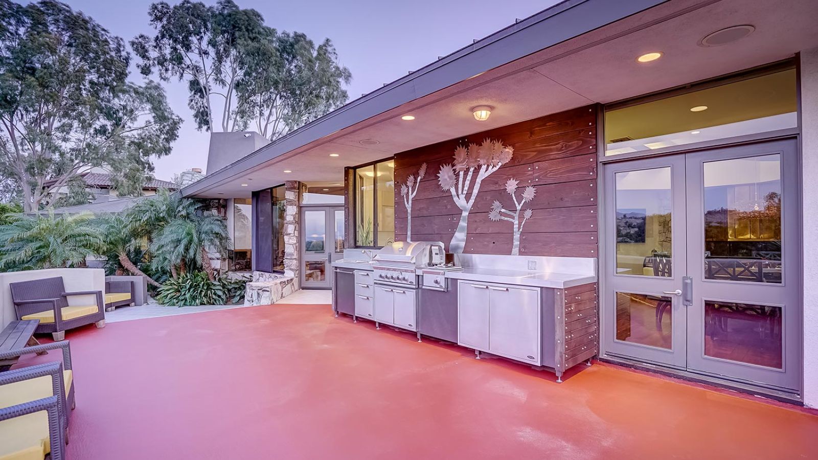 Outdoor kitchen area with a modern grill and stylish wall design.